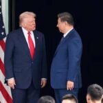 US President Donald Trump and Chinese President Xi Jinping talk as they leave after a bilateral meeting at Gimhae International Airport, on the sidelines of the Asia-Pacific Economic Cooperation summit, in Busan, South Korea,