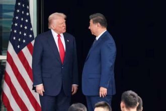 US President Donald Trump and Chinese President Xi Jinping talk as they leave after a bilateral meeting at Gimhae International Airport, on the sidelines of the Asia-Pacific Economic Cooperation summit, in Busan, South Korea,
