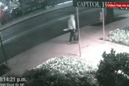 A dark, blurry security camera screenshot labeled "CAPITOL" with a timestamp of 8:14:21 p.m. and the location "am First St SE," noting the video has no sound.