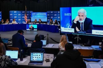 CDC panel meeting shown on a large screen as experts debate the hepatitis B newborn vaccine policy