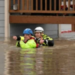 Rescue personnel prepare to evacuate residents from a home in an area flooded by the Snohomish River on 11 December.