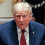 US President Donald Trump gestures as he attends a roundtable discussion on the day he announced an aid package for farmers, at the White House in Washington, DC, US