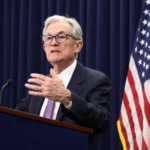 US Federal Reserve official speaking at a press conference about the latest interest rate cut.