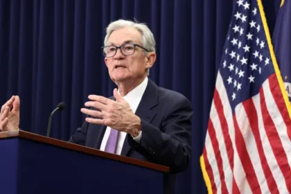 US Federal Reserve official speaking at a press conference about the latest interest rate cut.