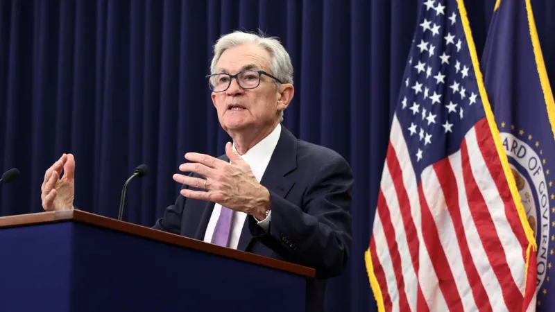 US Federal Reserve official speaking at a press conference about the latest interest rate cut.