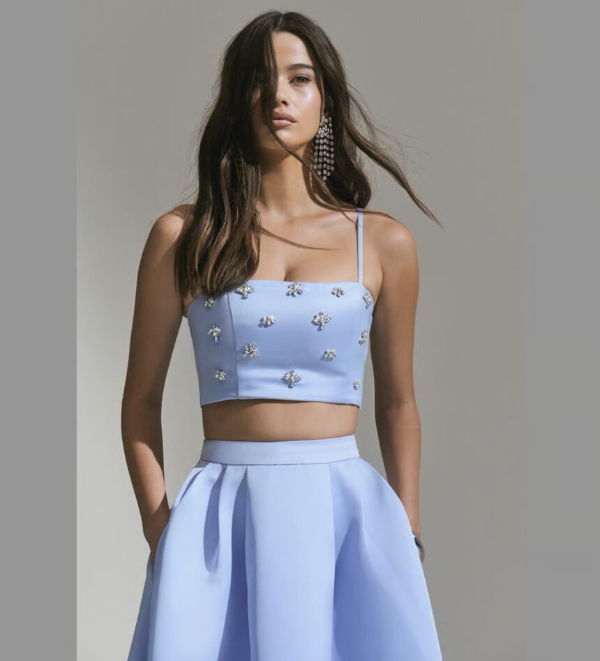 Model wearing a light blue embellished crop top and skirt from Club L London’s womenswear collection.