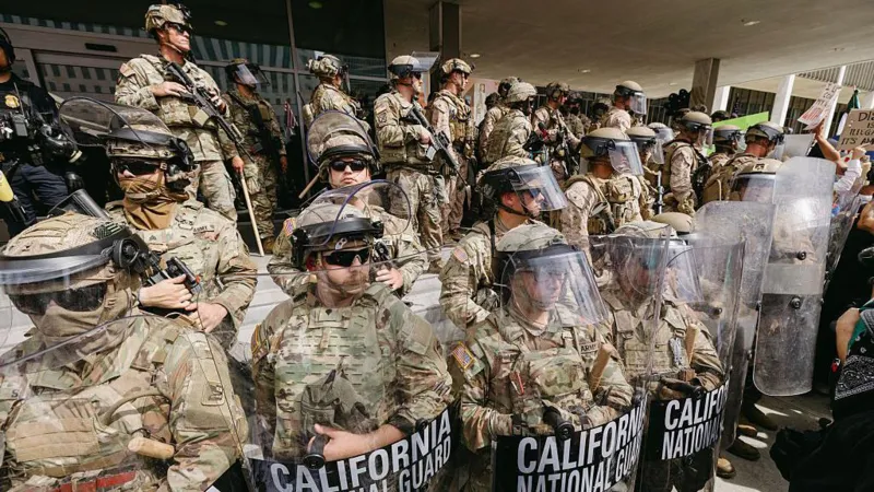 California National Guard troops in full riot gear standing in formation during a public protest response
