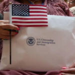 Immigrant holds US flag and USCIS documents as citizenship ceremonies are cancelled under new immigration restrictions