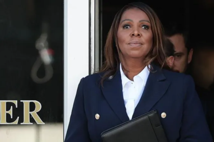 “Attorney general standing outside a building during coverage of the Letitia James indictment decision.”
