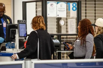 Airport screening line as travelers prepare for new US social media checks for tourists
