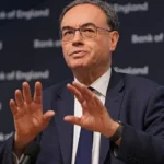 Bank of England governor warns AI may displace jobs, urges training and skills development while highlighting economic growth potential.