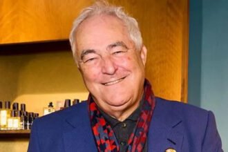 Many business leaders shy away from being labeled woke. Some even see it as an insult. Mark Constantine, the co founder and chief executive of Lush, feels the opposite. He openly embraces the term and has built his entire company around those values. Lush is widely known for mixing activism with its colorful bath bombs. Over the years, the brand has taken strong public positions on issues such as trans rights, police accountability, and humanitarian crises. These choices are not side campaigns. They sit at the heart of the business. At 73, Constantine continues to guide the company using the same principles that shaped it from the start. What began as a small shop in Dorset has grown into a global brand with 869 stores and yearly revenue of 690 million pounds. Despite this scale, the company has not softened its stance to please everyone. Lush has often taken actions that many retailers would avoid. It stepped away from several social media platforms due to concerns about their effects on young people. More recently, the company closed its stores for a full day to protest against starvation in Gaza. These moves drew attention, but they also reinforced the brand’s identity. Constantine describes himself as a nerd who loves learning. His mornings begin early, filled with meditation, posture practice, and writing about birdsong. Still, his message to critics of his values is direct. If you oppose what Lush stands for, he says, the shop may not be for you. This approach stands out at a time when many businesses avoid cultural and political topics to protect profits. Brands fear backlash or lost customers. Constantine believes that avoiding values is a bigger risk. He points to Ben and Jerry’s as another company known for activism. However, he feels their decision to sell the business weakened their independence. In his view, once a company is owned by others, it becomes harder to protect its original mission. Ben and Jerry’s co founder Ben Cohen has said the sale was not a choice but a legal outcome of being publicly traded. He adds that the brand’s social mission was written into the agreement and expresses respect for how Lush continues to use its voice without compromise. For Constantine, staying independent means staying honest. To him, business success and social responsibility do not cancel each other out. They work best when they move in the same direction