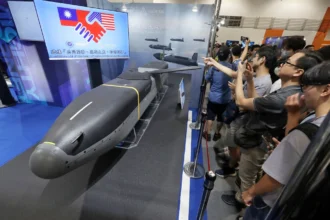 China sanctions 20 U.S. defense firms and 10 executives after a $10B arms sale to Taiwan, heightening tensions between the two nations.