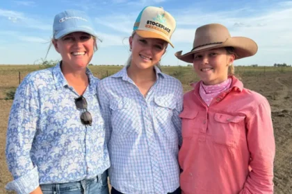 Teenagers using smartphones outdoors in rural Australia, highlighting digital connectivity and social media access challenges.