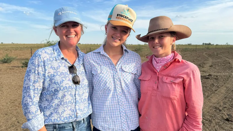 Teenagers using smartphones outdoors in rural Australia, highlighting digital connectivity and social media access challenges.