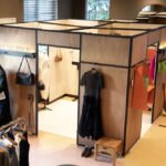 Interior view of the JW Anderson pop-up featuring curated clothing displays, accessories, and a minimalist modular layout.