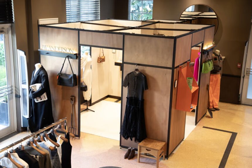 Interior view of the JW Anderson pop-up featuring curated clothing displays, accessories, and a minimalist modular layout.