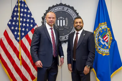 Dan Bongino smiling while speaking at FBI event, thanking Kash Patel for his praise