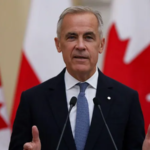 Canada’s prime minister speaks during an official address with Canadian flags in the background amid debate over British versus Canadian spelling