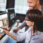 Fashion team reviewing an online clothing store interface on a desktop computer as part of digital retail strategy planning