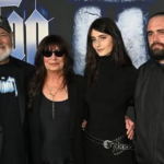 A group of family members posing together at a Hollywood film premiere event, shown amid news of murder charges filed in a high-profile Los Angeles case.