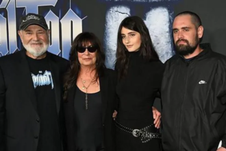 A group of family members posing together at a Hollywood film premiere event, shown amid news of murder charges filed in a high-profile Los Angeles case.