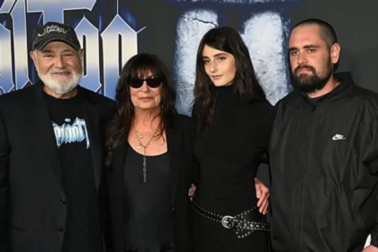 A group of family members posing together at a Hollywood film premiere event, shown amid news of murder charges filed in a high-profile Los Angeles case.