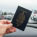 A hand holding a Canadian passport inside a car, symbolizing new citizenship rights under Canada’s Lost Canadians citizenship law.