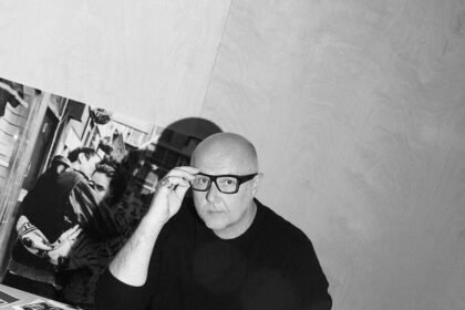 Fashion designer Mario Arena at his desk with a laptop and sketches, preparing for Joseph’s London Fashion Week return