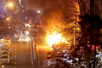 Iranian protesters hold Trump assassination image during Tehran University rally
