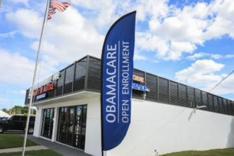 A worried couple reviewing medical bills and health insurance options under Obamacare bronze plans