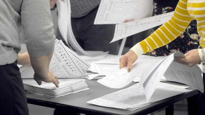 Texas Republican election officials reviewing ballots and discussing hand-count procedures ahead of the March primary elections.