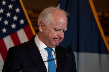 Governor Tim Walz speaking at a press conference in Minnesota, discussing his decision to end his re-election campaign amid a statewide fraud scandal.