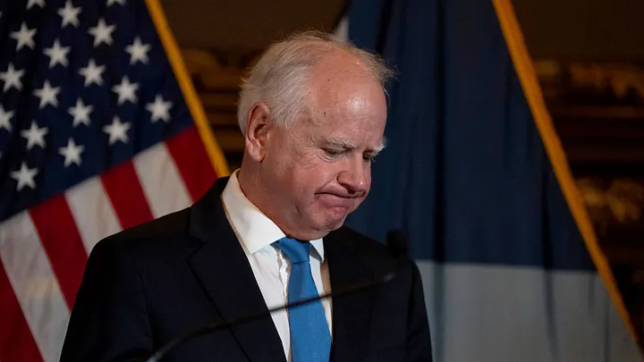 Governor Tim Walz speaking at a press conference in Minnesota, discussing his decision to end his re-election campaign amid a statewide fraud scandal.