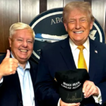 President Donald Trump holds a signed “Make Iran Great Again” hat while standing next to Sen. Lindsey Graham as nationwide protests continue across Iran over political corruption and rising fuel prices.