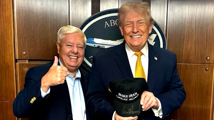 President Donald Trump holds a signed “Make Iran Great Again” hat while standing next to Sen. Lindsey Graham as nationwide protests continue across Iran over political corruption and rising fuel prices.
