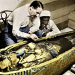 A Gasp of Wonder: Howard Carter Unearths Tutankhamun’s Tomb On 12 February 1923, Howard Carter and his team finally revealed Tutankhamun’s sarcophagus after decades of careful excavation. “A gasp of wonderment escaped our lips,” Carter said, recalling the breathtaking sight of the golden coffin and its intricate treasures. Thirty-three centuries had passed since anyone last walked inside the tomb, yet signs of life, like a half-filled bowl of mortar and scattered wood chips, made it feel almost alive. Carter described entering a golden shrine, sealed and untouched, then opening a second, even more stunning shrine that held an immense yellow quartzite sarcophagus. Howard Carter: From Draughtsman to Archaeologist Despite leaving school at 15, Carter’s talent for drawing led him to Egypt. At 17, he began working as a draughtsman and tracer, learning on the job during Egypt’s archaeological boom. Decades of experience and careful persistence in the Valley of the Kings finally led to his greatest success: uncovering Tutankhamun’s nearly intact tomb, hidden under centuries of debris. The Moment That Sparked Egyptomania In November 1922, Carter peered through a small hole in the tomb’s door. His patron, Lord Carnarvon, anxiously asked if he could see anything. Carter famously replied, “Yes, wonderful things.” Inside, gold glimmered everywhere—strange statues, animals, and artifacts designed to accompany the young pharaoh into the afterlife. Tutankhamun was only about 17 at his death, having inherited the throne at eight or nine. The exact cause of his death remains uncertain, with theories ranging from a hunting accident to assassination. Global Fame and the Curse Myth Carter’s discovery of the antechamber in 1922 was just the start. It took 15 more months to reach the sarcophagus and reveal the boy king’s treasures. Newspapers around the world reported the sensational find, and the world’s fascination with ancient Egypt grew. Fashion, art, films, and music were all influenced by Tutankhamun’s golden age. Tragedy soon followed when Lord Carnarvon died of blood poisoning from an insect bite. Stories of a curse surrounding Tutankhamun fueled myths and heightened public interest, turning Carter and Carnarvon into international celebrities. The discovery of Tutankhamun’s tomb remains one of the most significant archaeological achievements in history, revealing not just treasures but also a deep connection to Egypt’s ancient past.