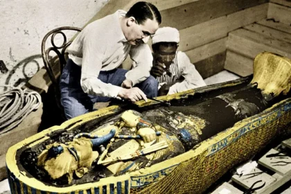 A Gasp of Wonder: Howard Carter Unearths Tutankhamun’s Tomb On 12 February 1923, Howard Carter and his team finally revealed Tutankhamun’s sarcophagus after decades of careful excavation. “A gasp of wonderment escaped our lips,” Carter said, recalling the breathtaking sight of the golden coffin and its intricate treasures. Thirty-three centuries had passed since anyone last walked inside the tomb, yet signs of life, like a half-filled bowl of mortar and scattered wood chips, made it feel almost alive. Carter described entering a golden shrine, sealed and untouched, then opening a second, even more stunning shrine that held an immense yellow quartzite sarcophagus. Howard Carter: From Draughtsman to Archaeologist Despite leaving school at 15, Carter’s talent for drawing led him to Egypt. At 17, he began working as a draughtsman and tracer, learning on the job during Egypt’s archaeological boom. Decades of experience and careful persistence in the Valley of the Kings finally led to his greatest success: uncovering Tutankhamun’s nearly intact tomb, hidden under centuries of debris. The Moment That Sparked Egyptomania In November 1922, Carter peered through a small hole in the tomb’s door. His patron, Lord Carnarvon, anxiously asked if he could see anything. Carter famously replied, “Yes, wonderful things.” Inside, gold glimmered everywhere—strange statues, animals, and artifacts designed to accompany the young pharaoh into the afterlife. Tutankhamun was only about 17 at his death, having inherited the throne at eight or nine. The exact cause of his death remains uncertain, with theories ranging from a hunting accident to assassination. Global Fame and the Curse Myth Carter’s discovery of the antechamber in 1922 was just the start. It took 15 more months to reach the sarcophagus and reveal the boy king’s treasures. Newspapers around the world reported the sensational find, and the world’s fascination with ancient Egypt grew. Fashion, art, films, and music were all influenced by Tutankhamun’s golden age. Tragedy soon followed when Lord Carnarvon died of blood poisoning from an insect bite. Stories of a curse surrounding Tutankhamun fueled myths and heightened public interest, turning Carter and Carnarvon into international celebrities. The discovery of Tutankhamun’s tomb remains one of the most significant archaeological achievements in history, revealing not just treasures but also a deep connection to Egypt’s ancient past.