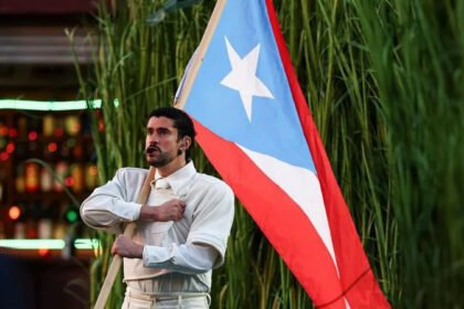 A Historic Performance in Spanish On Sunday, Bad Bunny made history as the first artist to perform a Super Bowl halftime show entirely in Spanish. For Puerto Ricans like me, the performance felt personal. Many of us have heard comments about our Spanish being hard to understand. Bad Bunny’s show reminded us that our language and culture matter on the biggest stages. Shared Beginnings I connect with Bad Bunny because, like him, I once worked in a supermarket, packing groceries and pushing carts under the Caribbean sun. Many Puerto Ricans share this experience, which shaped our understanding of hard work and community. It’s more than just a job. It’s about our humble beginnings, the neighborhoods we grew up in, and the resilience that comes from small-town life. Growing Up in Small Towns Bad Bunny, born Benito Martínez Ocasio, grew up in Vega Baja, a northern town in Puerto Rico. I grew up in San Lorenzo, in the southeast. His mother was a schoolteacher, his father a truck driver with no music connections. My mother worked in a factory, far removed from media or entertainment. Childhood for both of us felt distant from San Juan, even though the capital was just 45 minutes away. Trips to the city were special events, usually focused on visiting Plaza Las Américas, a massive shopping mall. Bad Bunny described it as a place where "you didn’t even know where you were standing." Language and Opportunity Like Bad Bunny, I learned English as an adult and still speak with a non-native accent. Many Puerto Ricans face the same challenge. According to the latest U.S. census data, only 22% of the island’s population feels confident speaking English "very well." Access to private lessons often depends on affordability. Life Under Strain Daily life in our towns moves slowly. Limited public transportation, few tourists, and a lack of major events shape our communities. We have endured political and economic struggles, including public debt crises and bankruptcy. These hardships affect electricity, schools, migration, and public services. In 2018, Bad Bunny referenced these issues in his song Ser Bichote: "Schools are closing while puntos open. So what do I do? Tell me, I’m asking you." The "puntos" are drug-selling spots our parents warned us about. Only Puerto Ricans truly understand the weight of that line, though everyone enjoys the music. Why It Resonates Bad Bunny’s Super Bowl show isn’t just entertainment. It’s a reflection of Puerto Rican identity, language, and shared struggles. Watching him on stage, I saw my own experiences mirrored in his journey.