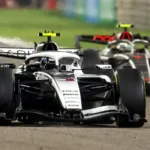 Audi and Cadillac Enter F1: Same Goal, Different Paths Two major car brands are entering Formula 1 in 2026, each with the same ambition but very different approaches. Audi has taken over the Sauber team, while Cadillac, under General Motors, is building a team from scratch. Both see F1’s new hybrid engine rules as a perfect marketing platform for their road-car technologies. Audi: Transforming an Existing Team Audi’s strategy focuses on transforming Sauber into a competitive F1 team. The team has a mix of trackside and factory leadership. Jonathan Wheatley, formerly of Red Bull, manages operations at the track, while Mattia Binotto, ex-Ferrari, runs the technical and factory side. Audi also builds its own engine at Neuburg while improving Sauber’s Hinwil base in Switzerland. Despite early struggles from underinvestment, the team showed progress in 2025, with veteran driver Nico Hulkenberg achieving a podium at the British Grand Prix. Early tests suggest Audi sits in the midfield, competing with Haas, Alpine, and Racing Bulls, while slightly ahead of Williams. The team aims to compete for championships within five years. Cadillac: Building From Scratch Cadillac faced a different challenge. Starting fresh, they had to create an entire team while dealing with F1 politics and delays. Initially, Andretti Global tried to enter the sport, but the bid was rejected. After restructuring and strengthening GM’s role, the entry was approved. Team principal Graeme Lowdon leads the project, supported by technical director Nick Chester. The team operates across multiple locations: Silverstone in the UK, Warren, Michigan, and Charlotte, North Carolina. A new facility in Indiana will serve as the main manufacturing center. Unlike Audi, Cadillac relies on Ferrari customer engines until their own power unit arrives in 2029. The flat management structure and peer-to-peer communication model aim to handle the geographical challenges. Different Challenges, Same Ambition Audi focuses on transforming an existing team and integrating a new engine. Cadillac builds a team and culture from scratch, planning for the long-term with its own power unit. Audi is ready to compete in the midfield immediately, while Cadillac’s real performance will likely start once their engine program is complete. Both have ambitious goals, but they approach F1 from different angles. Key Takeaways Audi transforms Sauber with a strong technical and leadership team. Cadillac builds from zero with a flat, NASA-style management system. Both see F1’s hybrid rules as marketing for their road cars. Audi targets titles within five years; Cadillac has limitless ambitions.