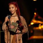 Standing on a global stage and holding a Grammy is a dream many artists chase. For FKA Twigs, that moment came after years of steady work, patience, and belief in her craft. At the 68th Grammy Awards in Los Angeles, the singer won Best Dance or Electronic Album for Eusexua. While fans saw a breakthrough, Twigs made it clear that her journey began long ago. Early talent in Cheltenham Born Tahliah Barnett, FKA Twigs grew up in Cheltenham. Dance teacher Corraine Collins first met her when she was just six years old. Collins remembers her as an energetic and expressive child who stood out from the start. She trained in ballet, modern dance, and tap at Collins’ studio. According to her teacher, Twigs showed natural stage presence early on. She brought emotion and drama into every performance, even as a child. Collins said she knew Twigs had something special. She did not follow rules or fit into set patterns. Instead, she created her own style. A move that shaped her future At 17, Twigs moved to London to study at the BRIT School. Dance remained important, but her focus slowly shifted toward music. That change would shape her career. Years later, she returned to Cheltenham with big news. At 22, she visited Collins to share that she had signed her first record deal. The moment meant a lot to both student and teacher. Collins described the visit as emotional. She said the studio felt proud, as Twigs became their first student to rise as a pop star. Recognition after years of work On stage at the Grammys, Twigs spoke honestly about her path. She said many people see her as new, but she has worked for a long time to reach this point. She shared a message for other artists. She urged them not to quit and to trust their vision. She said staying true to one’s art is what connects with people. Her words struck a chord with Collins. She said success today often feels rushed, but real growth takes time. Twigs’ journey proves that steady effort still matters. A message that resonates FKA Twigs’ Grammy win reflects more than talent. It shows dedication, resilience, and patience. Her story reminds young artists that success does not happen overnight. From a dance studio in Cheltenham to music’s biggest stage, Twigs stayed committed to her path. That commitment finally earned global recognition.