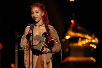 Standing on a global stage and holding a Grammy is a dream many artists chase. For FKA Twigs, that moment came after years of steady work, patience, and belief in her craft. At the 68th Grammy Awards in Los Angeles, the singer won Best Dance or Electronic Album for Eusexua. While fans saw a breakthrough, Twigs made it clear that her journey began long ago. Early talent in Cheltenham Born Tahliah Barnett, FKA Twigs grew up in Cheltenham. Dance teacher Corraine Collins first met her when she was just six years old. Collins remembers her as an energetic and expressive child who stood out from the start. She trained in ballet, modern dance, and tap at Collins’ studio. According to her teacher, Twigs showed natural stage presence early on. She brought emotion and drama into every performance, even as a child. Collins said she knew Twigs had something special. She did not follow rules or fit into set patterns. Instead, she created her own style. A move that shaped her future At 17, Twigs moved to London to study at the BRIT School. Dance remained important, but her focus slowly shifted toward music. That change would shape her career. Years later, she returned to Cheltenham with big news. At 22, she visited Collins to share that she had signed her first record deal. The moment meant a lot to both student and teacher. Collins described the visit as emotional. She said the studio felt proud, as Twigs became their first student to rise as a pop star. Recognition after years of work On stage at the Grammys, Twigs spoke honestly about her path. She said many people see her as new, but she has worked for a long time to reach this point. She shared a message for other artists. She urged them not to quit and to trust their vision. She said staying true to one’s art is what connects with people. Her words struck a chord with Collins. She said success today often feels rushed, but real growth takes time. Twigs’ journey proves that steady effort still matters. A message that resonates FKA Twigs’ Grammy win reflects more than talent. It shows dedication, resilience, and patience. Her story reminds young artists that success does not happen overnight. From a dance studio in Cheltenham to music’s biggest stage, Twigs stayed committed to her path. That commitment finally earned global recognition.