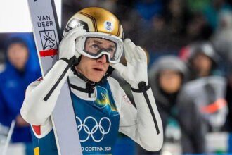 Daniel Tschofenig Disqualified Over Oversized Boots at Major Ski Jump Event Austrian ski jumper Daniel Tschofenig has admitted he felt “extremely stupid” after officials disqualified him from the men’s large hill individual event because of oversized boots. The 23 year old had safely qualified for the final and looked set to compete for a medal. However, equipment checks revealed that his boots exceeded the permitted size by four millimetres. Under international ski jumping rules, even a small measurement error leads to automatic disqualification. Costly Equipment Mistake Ends Medal Hopes Tschofenig, the 2025 World Cup champion, delivered a strong first round jump and scored 137.7 points. His performance placed him comfortably within qualification range. Soon after, judges inspected his gear and discovered the violation. Officials immediately removed him from the competition. As a result, Slovakia’s Hektor Kapustik advanced to the final round. Speaking after the incident, Tschofenig accepted full responsibility. He explained that he had trained in new boots that he did not particularly like. Despite his doubts, he decided to continue using them. He admitted that he failed to measure them properly due to pressure and stress around the event. He said the mistake was naive and emphasized that rules must apply equally to everyone. Prevc Wins Gold as Podium Shifts With Tschofenig out of the competition, the final standings changed. Slovenia’s Domen Prevc claimed the gold medal after a strong performance. Japan’s Ren Nikaido secured silver, while Poland’s Kacper Tomasiak earned bronze. The disqualification reshaped the medal race and opened the door for other competitors to step up. Growing Scrutiny Over Ski Jumping Equipment Rules The incident comes at a time when equipment regulations in ski jumping have drawn increased attention. Recent reports suggested that some male athletes injected hyaluronic acid before suit measurements in an attempt to influence results. Those claims raised fresh concerns about compliance and fairness in the sport. Strict equipment checks remain a core part of ski jumping competitions. Officials measure boots, skis, and suits carefully to ensure that no athlete gains an unfair advantage. Another Disqualification in Women’s Event The equipment controversy did not end there. On Sunday, American ski jumper Annika Belshaw also faced disqualification in the women’s large hill individual event. Judges found that her skis exceeded the maximum allowed length by more than one centimetre. Like Tschofenig, the 23 year old had qualified for the final. However, officials barred her from competing after the equipment check.