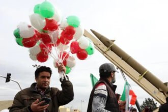 Iran Revolution Anniversary Rallies in Tehran Marked by Loyalty and Growing Discontent Massive Turnout in Tehran for Revolution Anniversary Tehran’s streets filled with large crowds as Iran marked the final day of its Islamic Revolution anniversary celebrations. Supporters of the government gathered in the capital and other major cities in a strong public display of loyalty. Officials treated the rallies as a direct response to recent anti government protests. Families walked together under a warm winter sun. The atmosphere felt festive. Children waved Iranian flags. Many people carried posters of Supreme Leader Ayatollah Ali Khamenei. Chants of “death to America” and “death to Israel” echoed through the streets, a familiar slogan at state organized events. The government’s most loyal supporters showed up in large numbers. Their presence sent a clear political message at a time when public frustration continues to grow over economic hardship. Support for the Revolution Still Runs Deep Many participants expressed strong pride in the 1979 revolution. A young woman wearing a long black veil described the revolution as a turning point for Iran. She said it revived the country and gave new life to society. In her view, its impact extended beyond Iran and influenced the wider Islamic world. Her words reflected a belief shared by many at the rally. For them, the revolution remains a source of identity and national strength. They see it as a symbol of independence and resistance against foreign influence. Acknowledging Economic Frustration At the same time, some supporters admitted that economic problems have caused real frustration. When asked about the recent protests, the young woman said that some people had valid concerns. She acknowledged that many Iranians struggle with rising prices and financial pressure. However, she drew a line between peaceful protest and unrest. She claimed that those who turned protests into chaos acted with motives linked to foreign actors. This argument mirrors the government’s stance. Officials often blame outside forces for fueling instability inside the country. Revolution Celebrations Overshadowed by Tension While the rallies projected unity and strength, they also highlighted divisions within Iranian society. The government aimed to show that it still commands strong public support. Yet the acknowledgment of economic dissatisfaction revealed deeper challenges. Iran continues to face international sanctions, inflation, and political pressure. These issues have sparked repeated protests in recent years. The anniversary events served both as a celebration and as a reminder of the tensions shaping the country today. As Iran reflects on decades since the revolution, the contrast between loyalty and defiance remains clear. Public celebrations showcased pride and commitment. But the undercurrent of economic frustration suggests that the conversation inside Iran is far from settled.