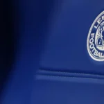 Leicester City Docked Six Points Over Financial Rule Breach Leicester City have lost six points after the English Football League ruled that the club broke financial regulations. The punishment takes effect immediately and pushes Leicester down the Championship table. The Foxes drop from 17th to 20th place and now sit just outside the relegation zone on goal difference. The decision comes at a difficult time for the club, both on and off the pitch. Why Leicester Were Penalised The Premier League charged Leicester in May for breaching profit and sustainability rules. The case covered the three year period ending in the 2023 to 2024 season. Under PSR rules, Premier League clubs cannot lose more than one hundred and five million pounds across three seasons. However, the allowed loss decreases by twenty two million pounds for every season spent outside the top division. Leicester spent part of that period in the Championship, which lowered their permitted spending limit. Club Losses Explained Leicester’s financial records show heavy losses over recent years. For the year ending June 30, 2024, the club reported a loss of nineteen point four million pounds. In the 2022 to 2023 season, Leicester confirmed losses of eighty nine point seven million pounds. The year before that, up to May 2022, the club recorded a record loss of ninety two point five million pounds. These figures do not include allowed adjustments. Clubs can exclude certain costs, such as stadium development and investment in women’s football, which both leagues consider beneficial to the sport. Leicester Responds to the Decision Leicester City strongly criticised the ruling. The club described the six point deduction as unfair and excessive. In an official statement, Leicester said the commission reduced the original punishment requested by the Premier League. However, the club believes the final decision still ignores key mitigating factors. Leicester confirmed they are reviewing the ruling carefully and weighing their next steps. The club also stressed its commitment to fair and transparent processes. On Field Struggles Continue The points deduction adds pressure to an already tough season. Leicester have failed to win their last four Championship matches and lost three of them. The club also remain without a permanent manager. Leicester dismissed Marti Cifuentes in January, leaving Andy King in charge as interim head coach. King will lead the team against Birmingham City on Saturday as Leicester fight to move clear of the relegation battle.