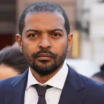 Actor Facing Serious Allegations Noel Clarke, known for his roles in Doctor Who and Kidulthood, has been arrested by the Metropolitan Police. He is suspected of attempted rape, exposure, and sexual assault by touching. The arrest follows an alleged incident that occurred in 2007 in London involving a woman in her 20s. Police Investigation Details Clarke, 50, attended Islington police station by appointment, accompanied by his wife and lawyer. Detectives from the Met’s Central Specialist Crime Command questioned him. He has been released on bail pending further investigation. A spokesperson for the Metropolitan Police confirmed the arrest also involves a voyeurism allegation for which Clarke was previously questioned in September 2025. This earlier allegation concerns an alleged 2013 incident in London involving a woman in her 20s. Career Collapse After Misconduct Allegations Clarke gained fame as Mickey Smith in Doctor Who from 2005 to 2010. He later became a writer, producer, and director. However, his career took a major hit in 2021 after multiple women came forward accusing him of sexual misconduct. Clarke denied the claims at the time. In 2023, Clarke lost a libel case against The Guardian and was ordered to pay at least £3 million of the newspaper’s legal costs. The Guardian estimated its total costs could reach £6 million. Clarke, who represented himself during the hearing, argued that the legal fees were excessive. Public and Industry Reactions The allegations have severely affected Clarke’s reputation in the entertainment industry. His projects have stalled, and he has largely remained out of the public spotlight since the allegations surfaced. The ongoing police investigation could further impact his career depending on the outcome. Next Steps in the Investigation The Metropolitan Police continue their inquiries. Clarke’s bail conditions remain in place while detectives examine both the 2007 and 2013 allegations. Further updates are expected as the investigation progresses.