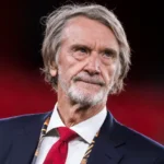 Jim Ratcliffe Immigration Comments Fallout: What It Means for Manchester United The fallout from Jim Ratcliffe’s immigration remarks continues to grow. The Manchester United co owner is now under review by The Football Association, and pressure is mounting from fans, politicians, and commercial partners. His words have triggered serious debate. The consequences could stretch far beyond headlines. FA Reviewing Possible Rule Breach The Football Association is reviewing whether Ratcliffe’s comments brought the game into disrepute. The governing body may charge him, issue a formal warning, or take no action. A charge would escalate the situation quickly. Even a warning would signal that football authorities take the matter seriously. The decision is expected soon. Manchester United Distances Itself Manchester United released a public statement emphasizing its inclusive and welcoming values. The club did not mention Ratcliffe directly. However, the message clearly created distance between the club and his remarks. Senior leadership approved the statement. That shows the level of concern inside Old Trafford. Ratcliffe later apologized. He said he regretted offending people but maintained that immigration policy should be controlled and well managed. Glazer Family and Brand Concerns The Glazer family, who still own 70 percent of the club, have not commented publicly. Sources suggest they were unhappy with the remarks. Manchester United operates as a global brand. Sponsors prefer to associate with positivity and inclusion. Political controversy creates risk, especially when commercial deals are already under pressure. The club currently lacks a training kit sponsor. Its sleeve sponsorship also expires this summer. Meanwhile, the Adidas agreement pays less after two seasons without Champions League football. Although United reported strong commercial revenue last year, competitors continue to close the gap. Stadium Project Could Face Challenges Ratcliffe invested £1.25 billion in 2024 for a 27.7 percent stake in the club. He also backs a proposed 100,000 seat stadium as part of a large Trafford regeneration plan. The project depends on cooperation from political leaders, including Greater Manchester Mayor Andy Burnham and Prime Minister Keir Starmer. Both criticized his comments. Public funding would support infrastructure around the stadium, not the stadium itself. Still, political relationships matter. This controversy arrives at a sensitive moment. One source close to the project said the situation caused real concern, even if it remains manageable. Supporter Reaction and Club Culture Fan groups responded quickly. The Manchester United Supporters Trust said leadership should make inclusion easier, not harder. The Manchester United Muslim Supporters Club called the apology a first step. Members want further reassurance that the club remains welcoming to all communities. Manchester United is one of the most globally diverse clubs in football. Its players, staff, and supporters come from many backgrounds. That makes language around immigration especially sensitive.