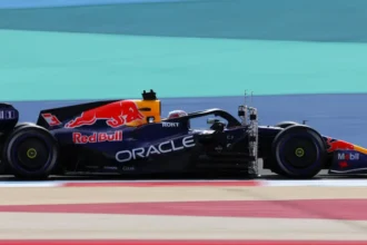 Red Bull Sets the Benchmark in F1, Says Mercedes Boss Wolff As Formula 1 pre-season testing kicks off in Bahrain, Mercedes team principal Toto Wolff has declared Red Bull as the team to beat this season. Lando Norris ended the first day of testing as the fastest driver, finishing 0.129 seconds ahead of Red Bull’s Max Verstappen. Despite this, Wolff believes Red Bull’s new engine gives them a clear advantage over rivals. Red Bull’s Engine Advantage Mercedes’ data shows Red Bull can deploy significantly more energy on the straights than other teams. Wolff explained that the team maintained a consistent advantage over 10 consecutive laps. “On a single lap, we’ve seen it before, but now they’re doing it over multiple laps,” Wolff said. “As of today, they have set the benchmark.” This season features the biggest rules overhaul in F1 history. Cars have new power units, chassis, tyres, and fuel. The 1.6-litre V6 turbo hybrid engines split power almost equally between internal combustion and electrical energy. Energy recovery and deployment are now key to performance. How Hybrid Engines Work The hybrid engines recover energy in four ways: braking, revving in corners, lifting off early, and harvesting while at full throttle. Teams must carefully manage energy deployment, as even small gains can determine competitiveness. Testing Times and Driver Performances Headline lap times during testing are often misleading because teams run cars in different specifications. Norris set his fastest lap on C2 tyres, while Verstappen used softer C3 tyres. Ferrari’s Charles Leclerc was third fastest, 0.521 seconds behind Norris, followed by Haas driver Esteban Ocon. Unlike most teams, Red Bull had Verstappen drive all day. Aston Martin also limited driving to Lance Stroll, marking the start of their Honda engine partnership and debuting a new car designed by Adrian Newey.