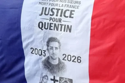 Student Death in Lyon Sparks Political Tension for French Far Left The death of a 23 year old student in Lyon has triggered a political storm in France, with senior ministers pointing fingers at far left activists. Quentin Deranque, a maths student and nationalist campaigner, died on Saturday. He suffered severe head injuries after a violent street assault two days earlier. Prosecutors say at least six people attacked him, kicking and punching him during the incident. An autopsy confirmed fatal damage to his skull and brain. What Happened in Lyon? The violence followed a small protest in Lyon on Thursday afternoon. Deranque had shown support for Némésis, a hard right feminist group. The group staged a demonstration against a visit by LFI Member of the European Parliament Rima Hassan to the city’s Institute of Political Studies, known as Sciences Po. Video recorded near the protest shows several young men being chased and beaten by a larger group. One man, believed to be Deranque, lay motionless on the ground after the attack. State prosecutor Thierry Dran said two groups first clashed briefly. Later, Deranque and two other nationalist activists tried to leave the area. A larger group cornered them and launched a second assault. Two members of Némésis were also injured during the earlier confrontation. Government Blames Far Left Militants Ministers in President Emmanuel Macron’s government quickly blamed far left activists for the killing. Interior Minister Laurent Nuñez described the attack as a “mob killing.” He said the attackers may not have intended to cause death, but their actions proved fatal. Justice Minister Gérald Darmanin was more direct. He stated that the far left killed Deranque and said there was no doubt about responsibility. Police have opened a murder investigation. Officers are working to identify suspects, but authorities have not made any arrests so far. Pressure on France Unbowed and Security Group The case has increased pressure on the radical left party France Unbowed, also known as LFI. Attention has also turned to La Jeune Garde, a group previously linked to security at LFI events. Members of Némésis claim they recognized activists from La Jeune Garde during the disruption of their protest. The group denies any involvement in the violence. Rima Hassan condemned the incident and called for a full investigation. She stated on social media that LFI provided her only security during the visit and said party members had no role in the assault. Family Responds Deranque’s lawyer, Fabrice Rajon, rejected claims that his client worked as a security agent. He said Deranque never engaged in violent activity and defended his political views peacefully. The incident comes at a tense moment in French politics, just weeks before key municipal elections. The investigation continues as authorities try to determine who carried out the deadly attack.