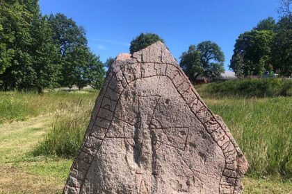 Ancient Viking Rune Stones Reveal Messages of Love, Loss, and Celebration in Sweden Runic inscriptions from the Viking Age continue to surface across Sweden, offering glimpses into lives lived more than 1,000 years ago. These ancient writings reveal personal messages, memorials, and even playful riddles, proving that the Vikings were not just warriors but storytellers and jokers. Discovery of a Rune Stone Near Stockholm A few years ago, Swedish rune expert Magnus Källström visited a farm south of Stockholm. A farmer had uncovered a stone while preparing to use it as a doorstep. When turned over, the slab revealed rows of ancient runes. Reading aloud, Källström deciphered: "Gärder erected this stone in memory of Sigdjärv his father, Ögärd's husband." The message had gone unread for almost a millennium. Rune Stones in Everyday Life Finding rune stones by accident is not unusual in Sweden and other Scandinavian countries. They often appear during construction projects, roadworks, or plowing fields. Some stones, like a 2,000-year-old example discovered in Norway in 2023, date back to the earliest days of runic writing. For many Swedes, rune stones are part of the landscape. They dot fields, roundabouts, and industrial areas. Roadside heritage signs often highlight their presence. Though familiar, these stones still hold mysteries and stories yet to be uncovered. The Origins of Runes The word "rune" comes from the Old Norse rún, meaning secret. Vikings used runes to capture northern European languages, including Old Norse. The script evolved from influences like the Latin alphabet, which traders and travelers encountered in southern Europe. Runes were carved on wood, bone, stone, and even tools. One 11th-century textile tool found outside Gothenburg reads: "Do you think of me, I think of you, do you love me, I love you." Stone inscriptions were the most durable and visible form. Some runes even appear on cliffs. Rune Stones as Memorials and Messages Rune stones often served as memorials, placed along roads, fords, or council sites to be seen by the public. They became especially popular during the Viking Age (800-1050 AD) and are sometimes called the social media of the time. Commissioning a rune stone was costly, often requiring a skilled carver. During the spread of Christianity, many stones included prayers or crosses. Runes for Fun and Jokes Not all runes were serious. Vikings also used them for humor. Källström mentions "riddle bones," where messages change when the object is rotated. Examples include instructions like "decipher this" or playful phrases such as "tasty beer." These show that Vikings enjoyed puzzles and social games. Rune stones remain a bridge to the past. They offer insights into Viking life, from love and loss to faith and humor. Every discovery adds a new chapter to their story.